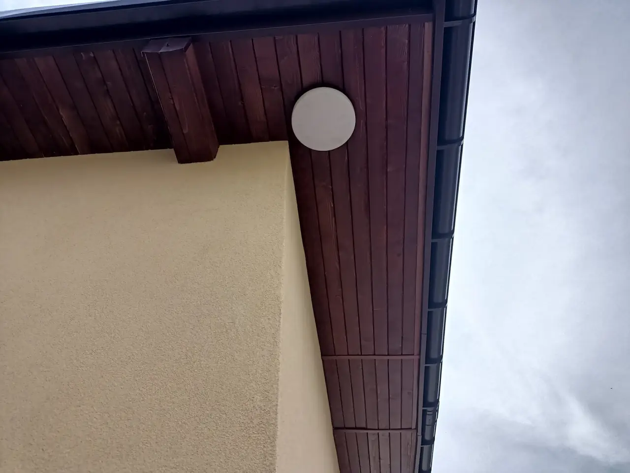 Wykończona podbitka drewniana pod okapem dachu, widok narożnika